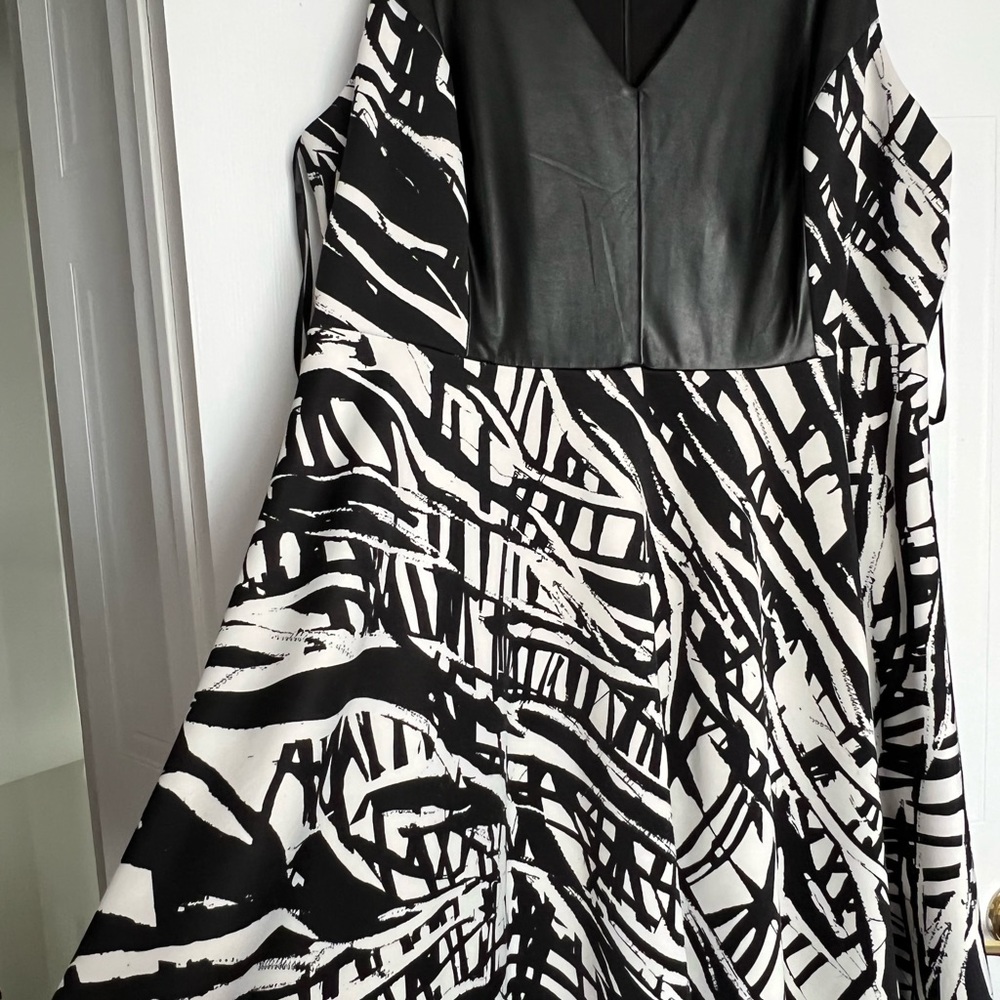 A line black dress with leather appliqué